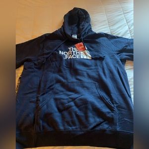 The North Face dark blue hoodie.  Never worn. Stored with other clothing.